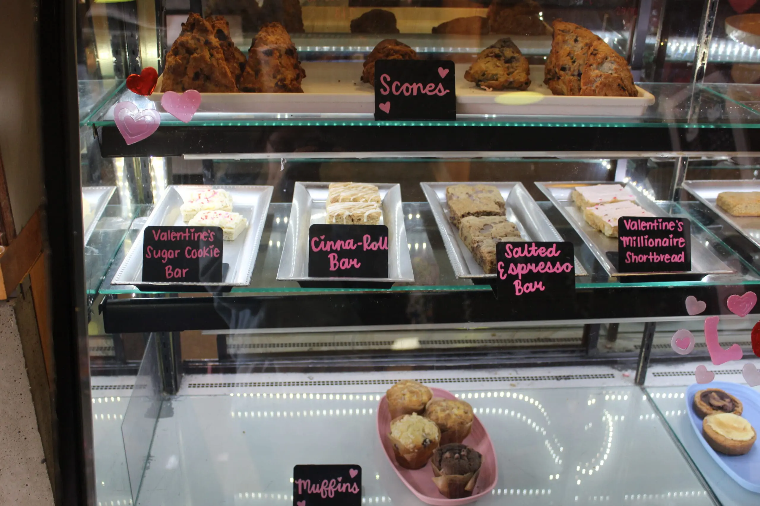 Cookies and pastries in a case on a blue, green, and pink plate