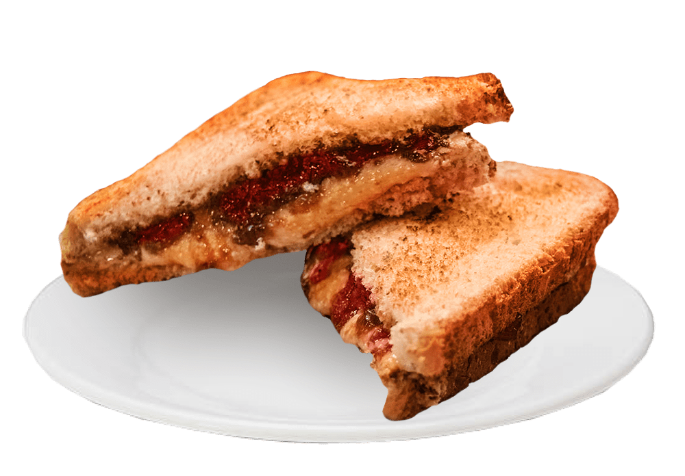 The image features a peanut butter and jelly sandwich on a plate. The jelly is grape, and the sandwich is toasted.